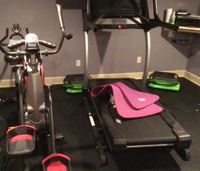 Home Gym affected by water damage, with drying equipment in place